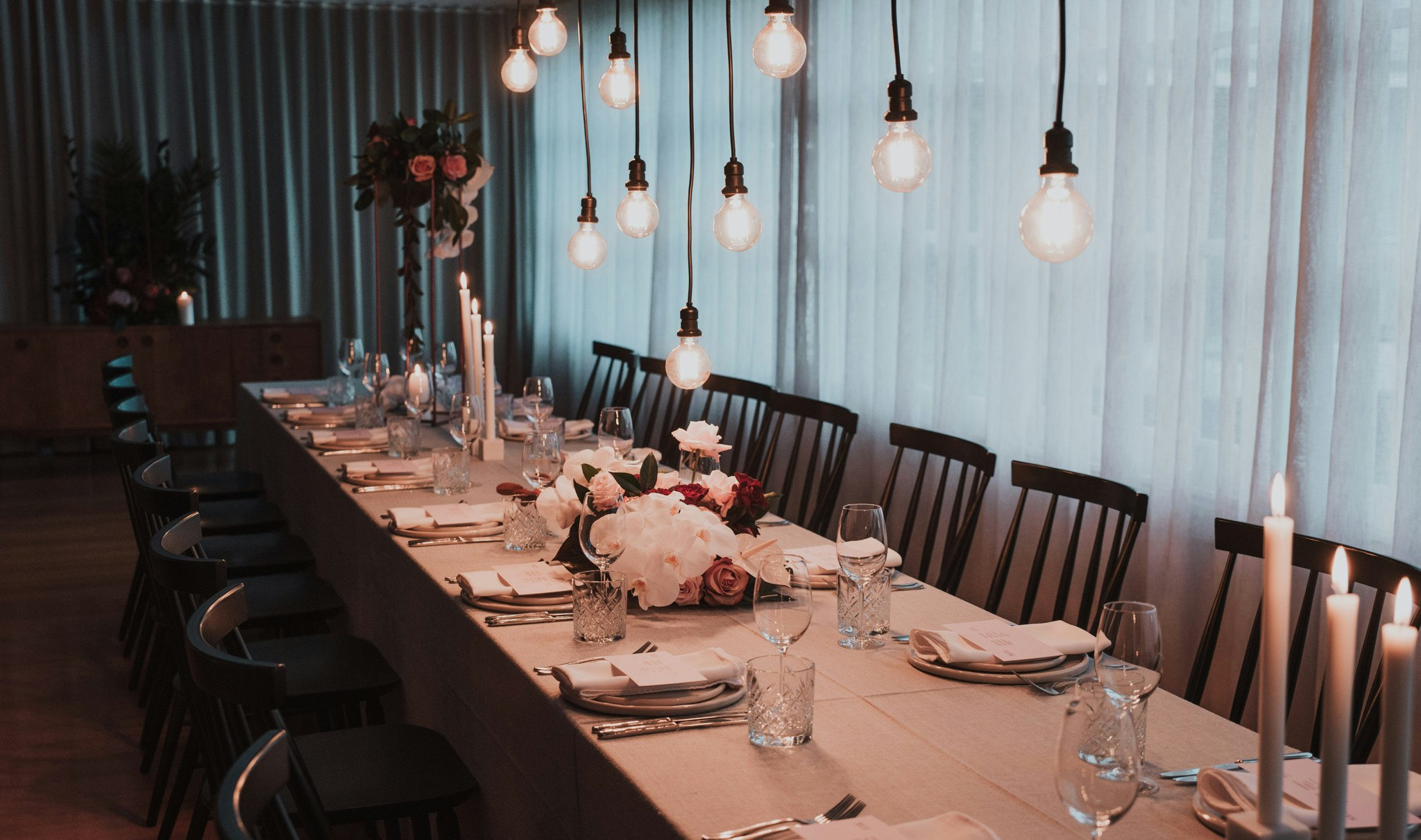 Light setting cast over a table set for a wedding reception.